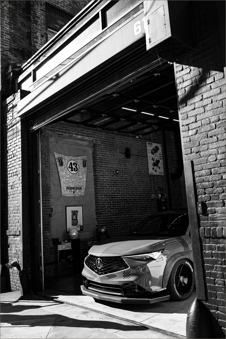 Monochrome frame of the Garage 619 entrance with a car just inside